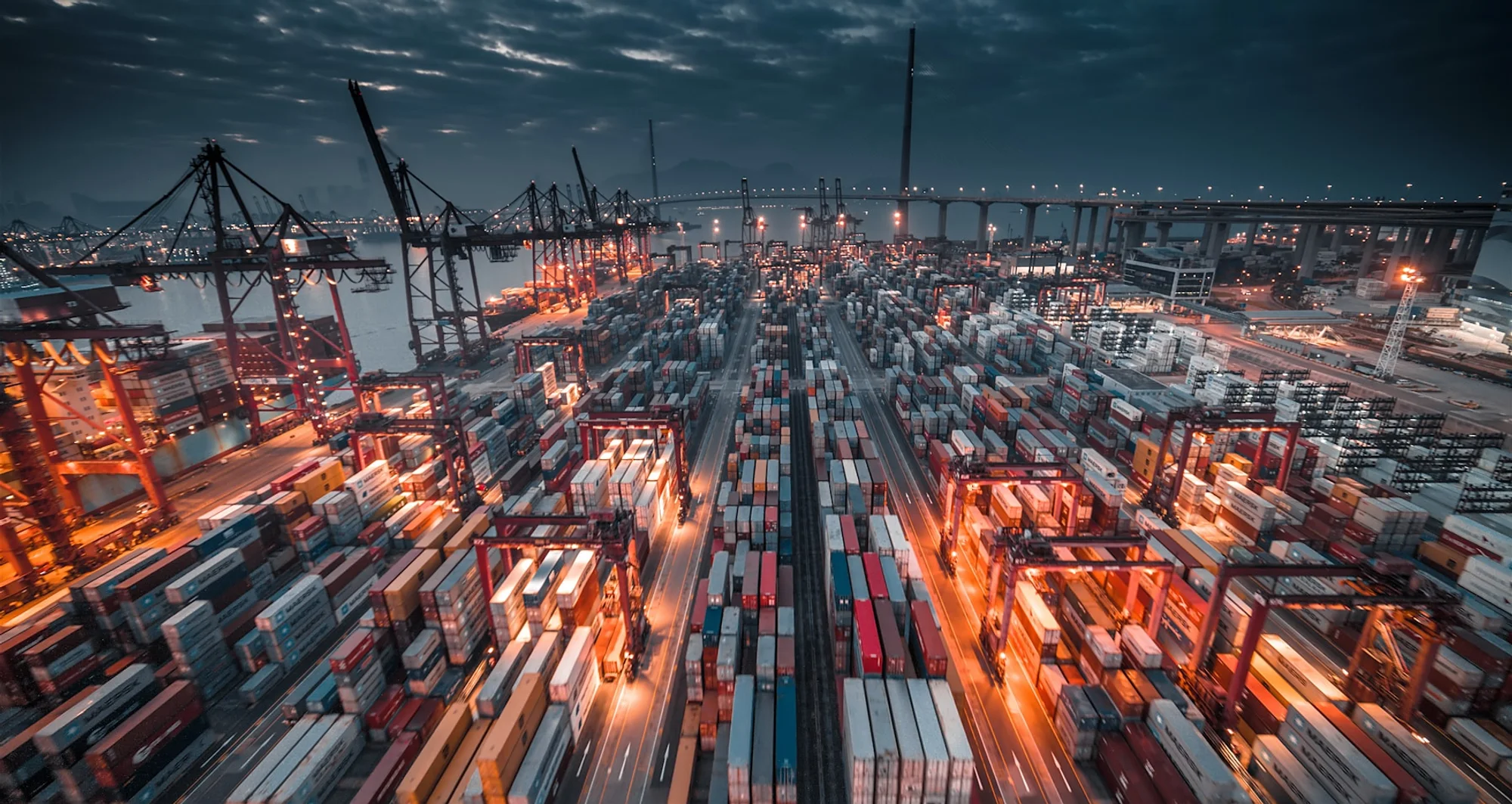 Port terminal operating at night with containers and cranes